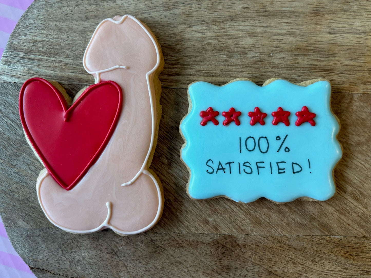 100% satisfied penis and heart custom decorated cookies available in your choice of color and design. Starting at $42/dozen.
